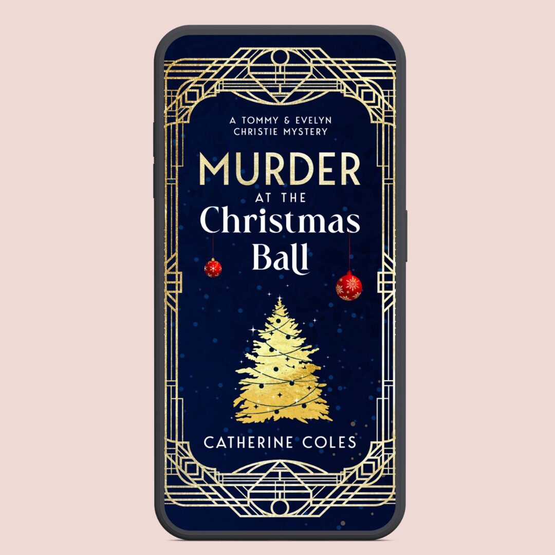 Book cover for Murder at the Christmas Ball by Catherine Coles, a Tommy & Evelyn Christie mystery. The cover features a dark navy blue background with an ornate gold Art Deco frame, the title in gold and white lettering, two red Christmas baubles hanging near the top, and a gold Christmas tree at the centre.
