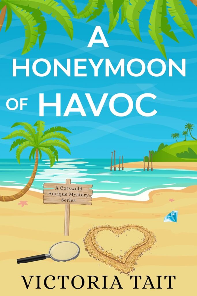Bright tropical illustrated book cover showing a golden sandy beach with turquoise sea, palm trees, a heart drawn in the sand, a magnifying glass, a sparkling diamond, and a wooden sign reading A Cotswold Antique Mystery Series